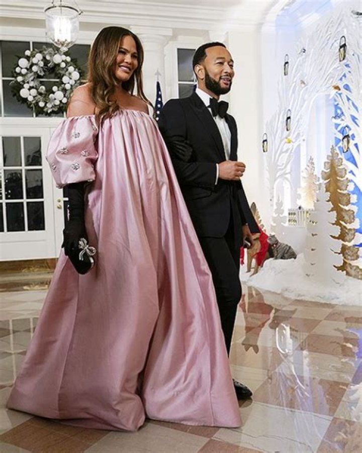 Exhausted Chrissy Teigen Puts Her Feet Up On Counter & Bump On Display After Thanksgiving