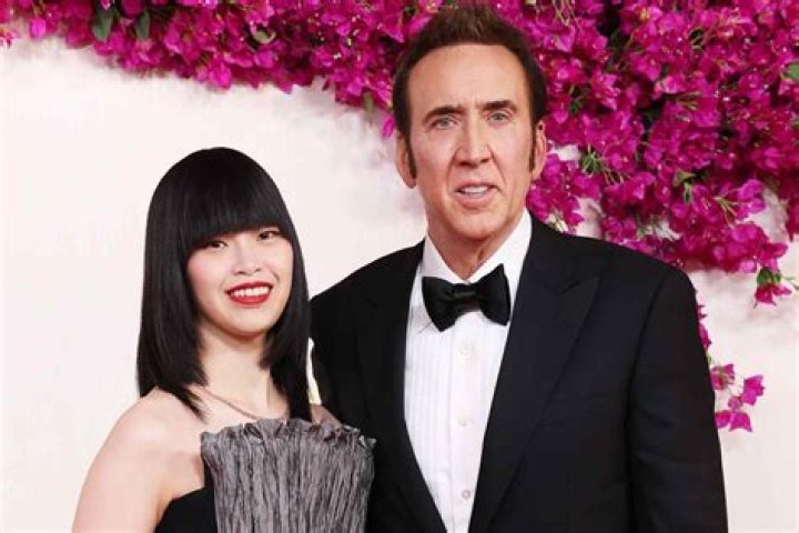 Nicolas Cage’s Wife Covers Baby Bump In Flowy Dress As They Hold Hands On Red Carpet